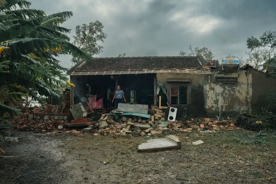 A rural house in Phú Yên, Vietnam, heavily damaged by a storm, showcasing nature's impact.